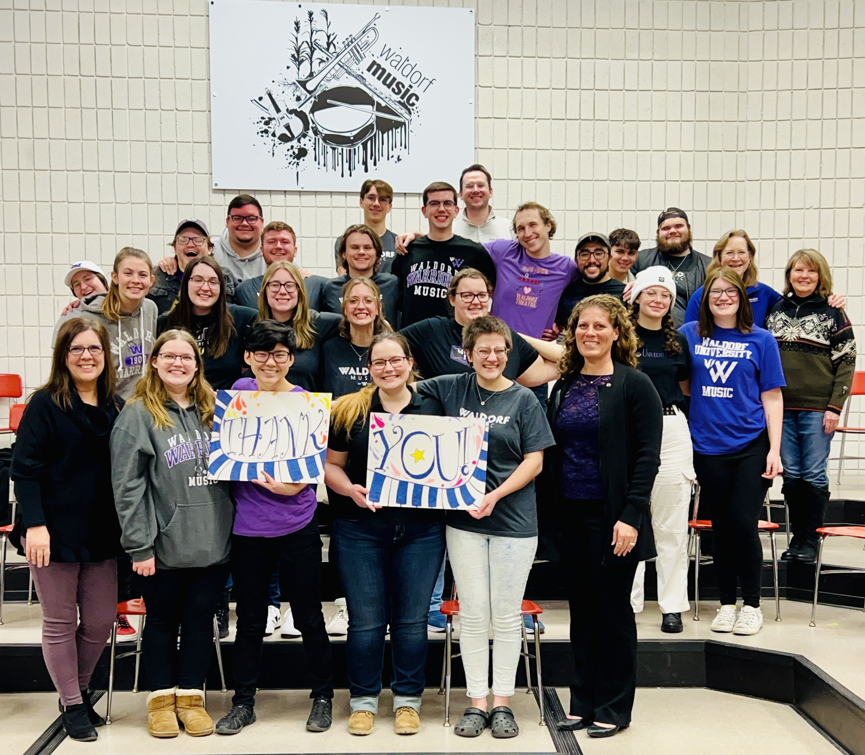 Waldorf Choir students and professors holding "Thank You" sign