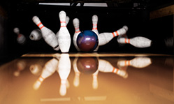 Bowling ball hitting pins