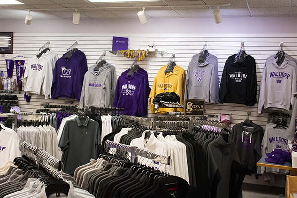 Variety of Waldorf shirts hanging in campus store