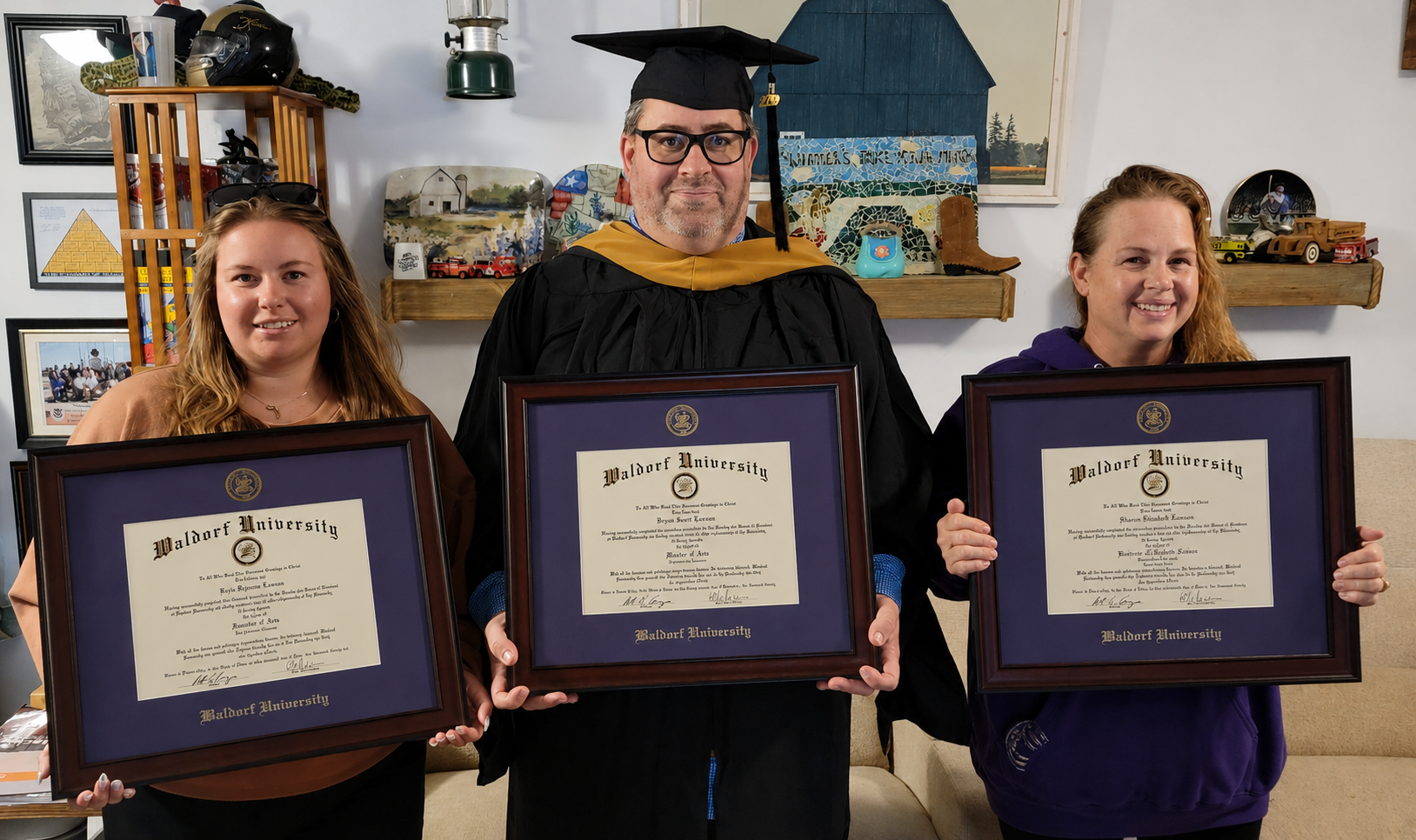 Waldorf graduates, Keely Lawson 2026, Bryan Lawson 2020, Shanon Lawson 2020, standing in line holding their Waldorf degrees